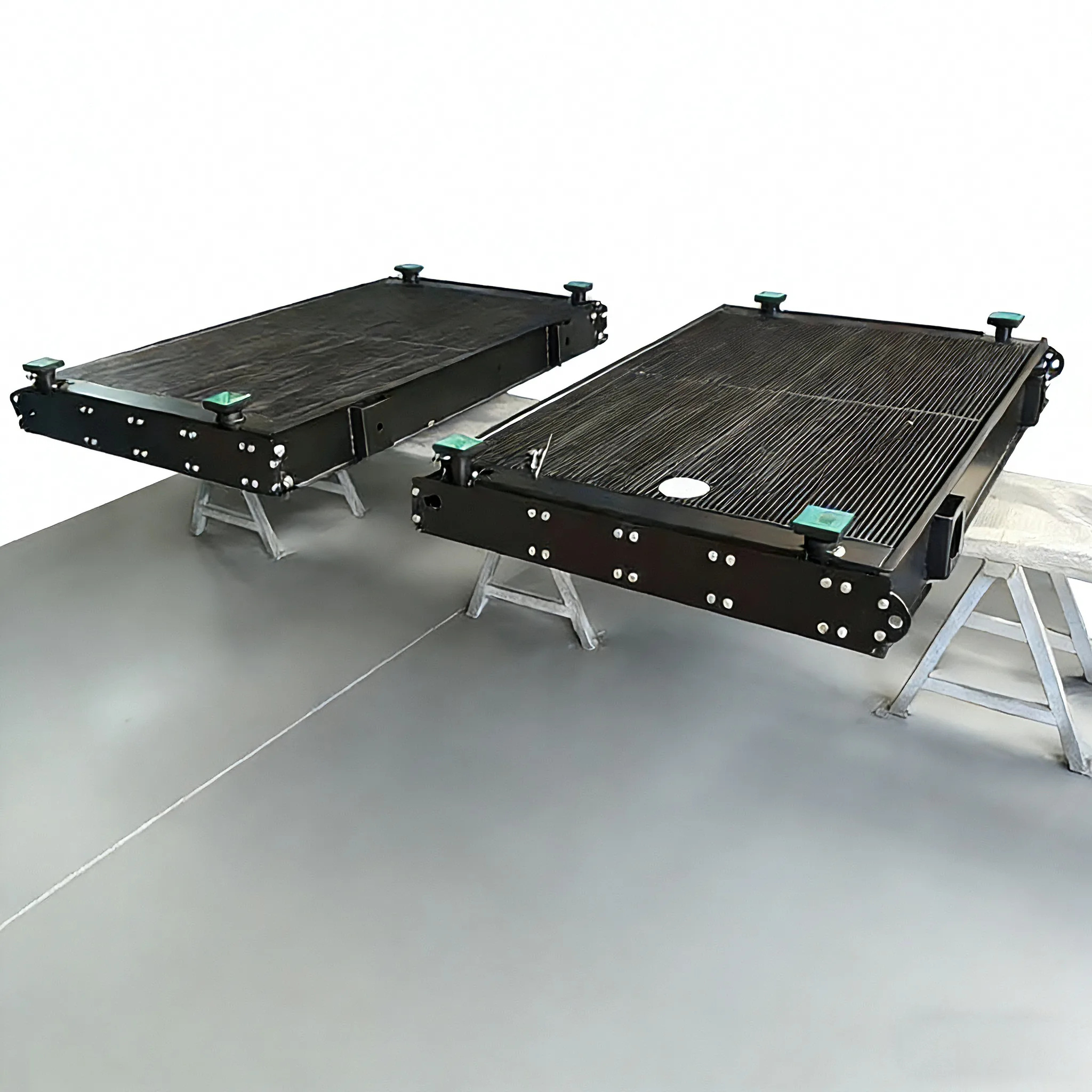 Two custom aluminum plate-fin oil coolers for diesel locomotives, showing mounting brackets and port structures